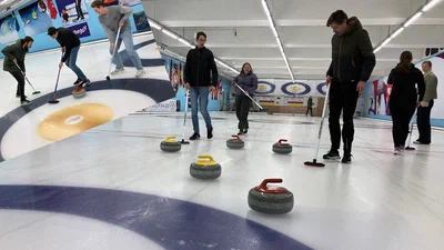 MReye team members at a curling clinic used as analogy for ocular radiotherapy